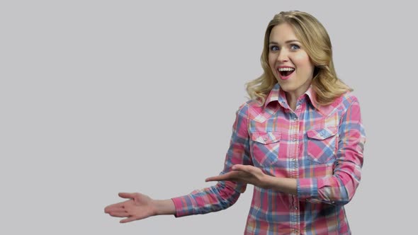 Shocked Young Blond Woman Showing Copyspace Holding Her Palms Up