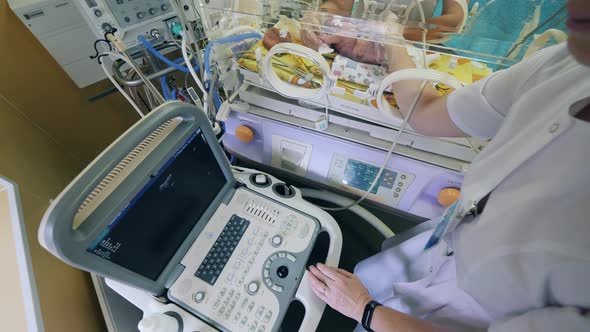 A Pediatrician Checks Baby, Using Ultrasound Machine.