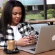 Young black woman typing on the phone in cafe. - VideoHive Item for Sale