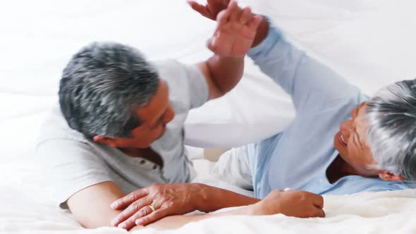 Senior couple embracing each other in bedroom 4k