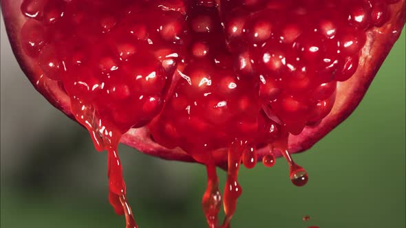 Flowing Pomegranate Juice From Half Pomegranate Macro Shot in Slow Motion