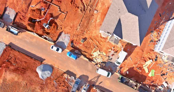 Construction of aerial top view on pouring the foundation for a new house with suburbs development.