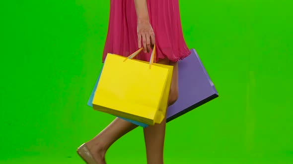 Girl Holding Shopping Bags. Green Scree. Slow Motion