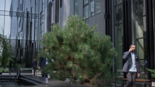 Confident Businessman Walking Downtown Office Building