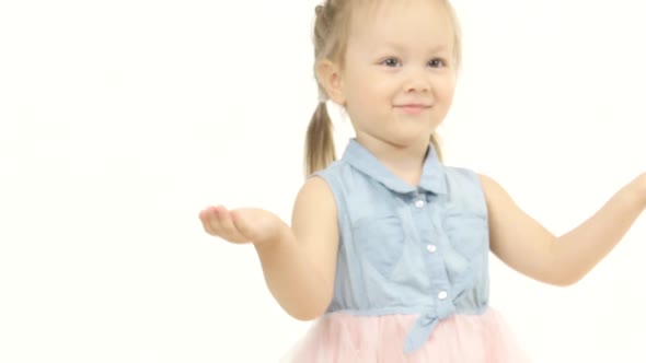 Child Is Standing and Clapping Wannabes and Twisting His Arms Around. White Background