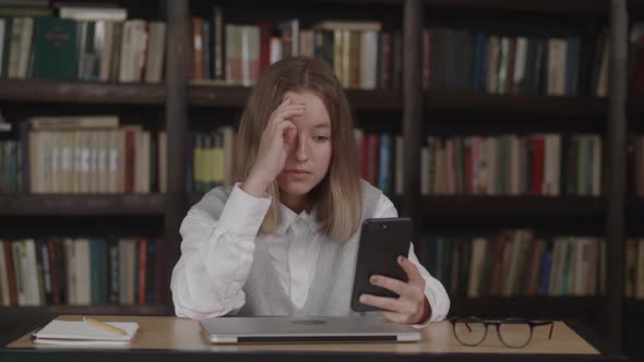 Young Schoolgirl with Short Hair in School Uniform Waving Hand Using Video Conference Call By Webcam