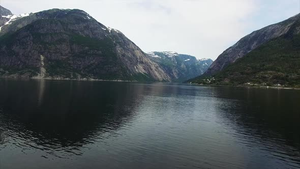 Flying above the dark waters of famous Hardanger fjord in Norway.