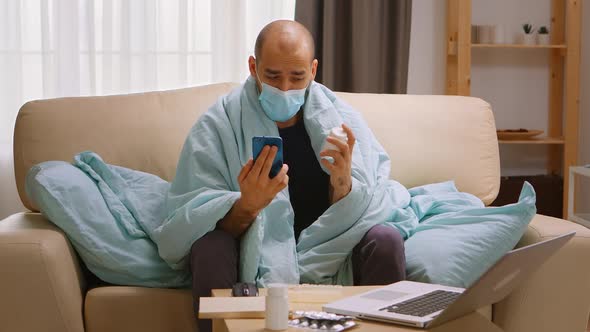 Sick Man on a Video Call with Doctor During Covid Isolation