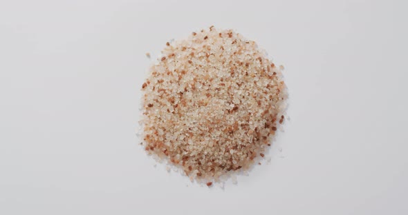 Video of pile of himalayan pink salt on white background