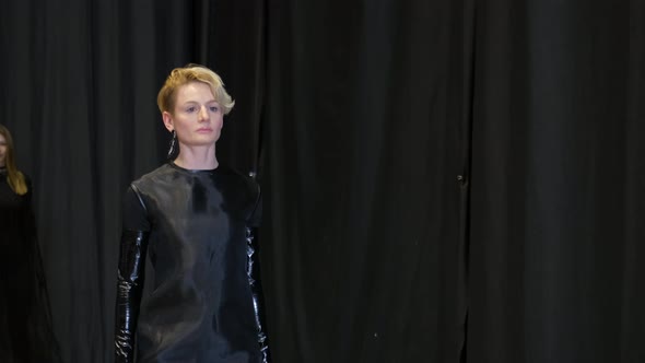 Blonde Female Model Walking on Black Curtain Background
