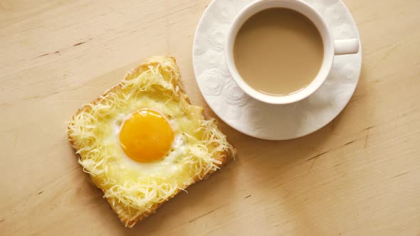 Top View of Toast with Fried Eggs and Coffee on Wooden Kitchen Table