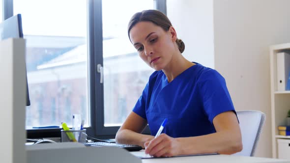 Doctor or Nurse with Computer Working at Hospital