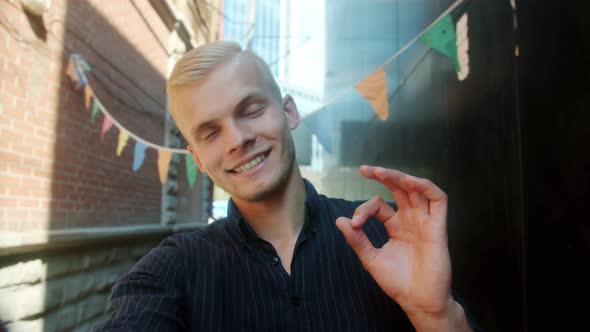 Slow Motion Point of View Portrait of Handsome Guy Taking Selfie Posing Looking at Camera Outdoors