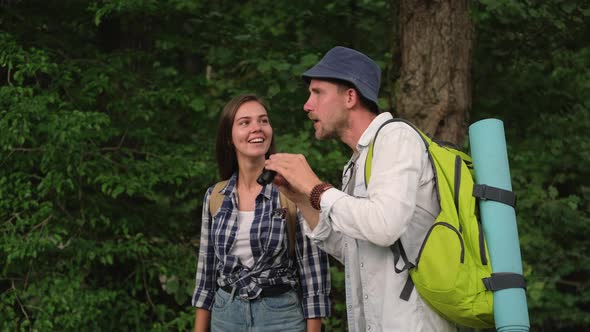 Two Hikers are Watching Wild Nature of Forest By Binocular