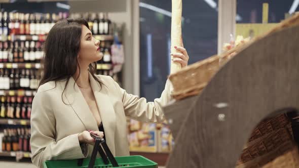Glamorous Lady Chooses Bakery in Supermarket Puts Into the Basket and Smiles