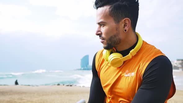 Man training at the beach outdoor gym