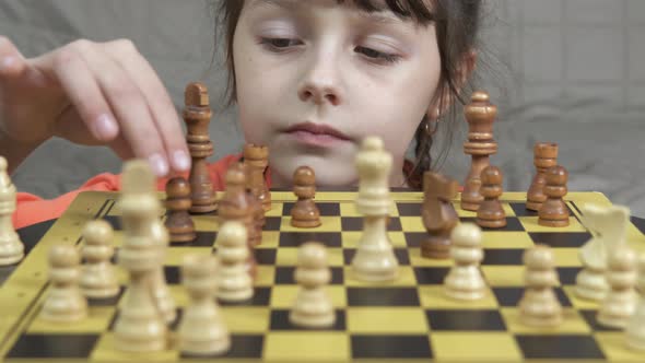 Alone child with chess board. 