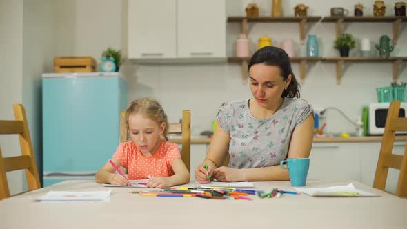 Mother Is Teaching Drawing Skills To Daughter