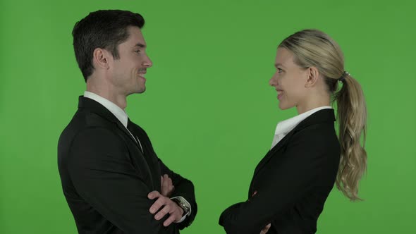 Attractive Male and Female Professionals Looking at Each Other and Smiling, Chroma Key