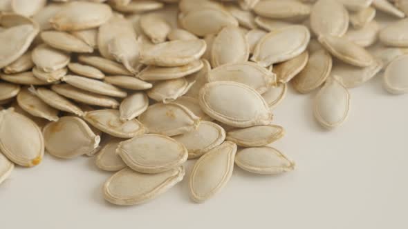 Pile of  pumpkin seed close-up 4K tilting footage. Edible pepitas on pile slow panning  video