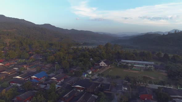 Cinematic Aerial View on Village in Mountains 