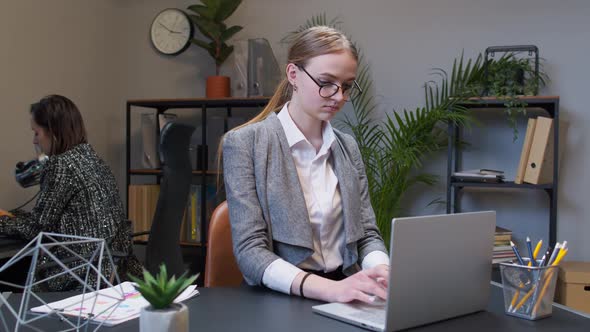 Joyful Business Woman Freelancer Concentrated Developing New Project While Looking on Laptop Screen