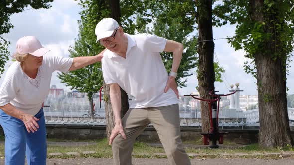 Elderly Grandfather with Low Back Pain During Morning Exercise