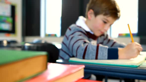 Boy doing homework in classroom 4k