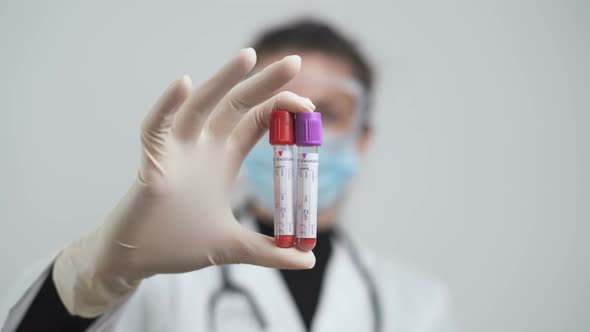 Female Hand Holding Blood Containers, Vacutainer Tubes at Laboratory for Coronavirus Tests