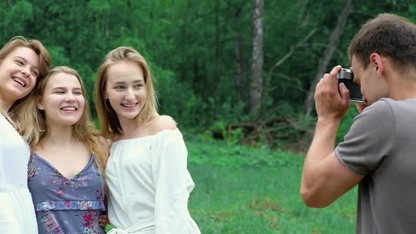 young people take group selfie on retro camera pose for camera have fun a picnic