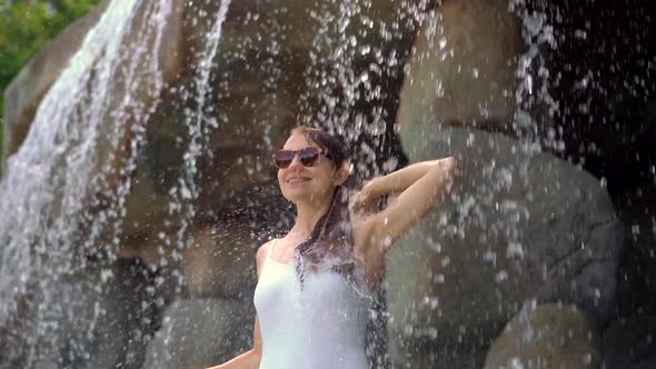 A Young Woman in a Tropical Resort with Hot Springs, Waterfalls and Swimming Pools with Hot Mineral