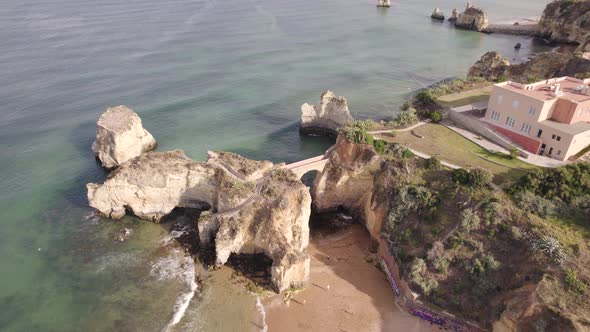 Aerial view of pont romain de Lagos, rock arch bridge at Praia dos Estudantes Algarve, Portugal.