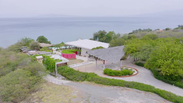 Seafront empty resort structure overlooking Caribbean ocean at Bahia de Ocoa bay in Dominican Republ