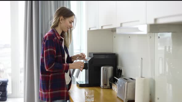 Woman Pouring Fresh Water Into Glass Drinking Water on Domestic Kitchen