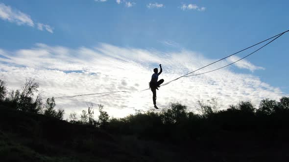 Beautiful Blue Sky on the Background of a Man Slacklining Extreme Sport