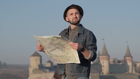 Young Traveler Man With Map Outdoors Ancient Castle Background