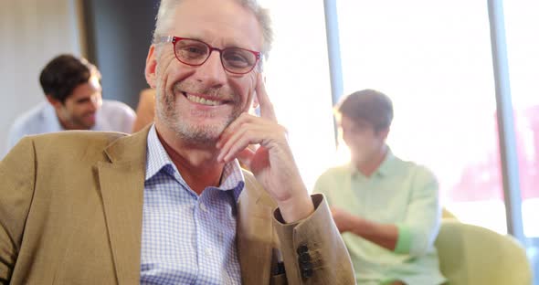 Portrait of businessman sitting in office