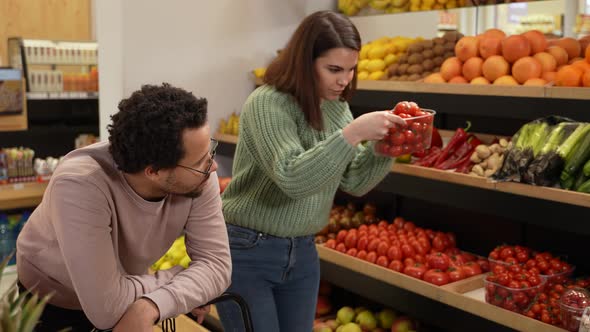 Sad Man Looking at Woman Choosing Vegan Products