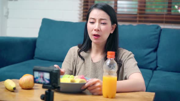 Asian women using camera streaming and recording vlog video about the benefit for broadcast online.