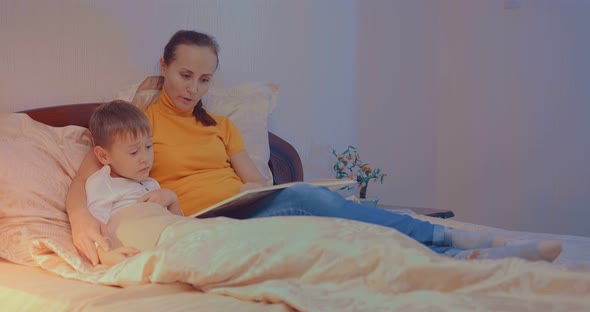 Mother and Child Reading a Book Before Bed Time