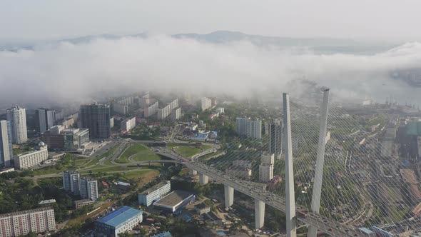 Drone View of the Golden Bridge in the Fog and the City at Sunset