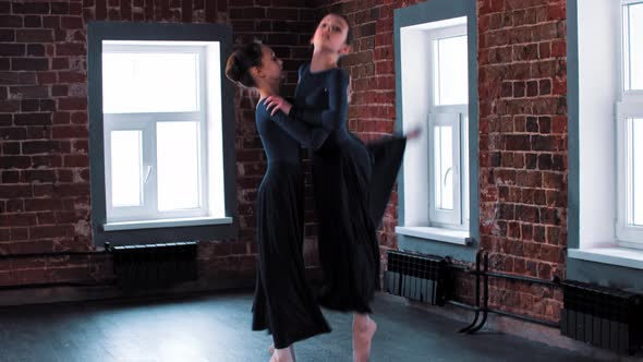 Two Little Ballerina Girls Dancing in Long Dark Dresses on Training