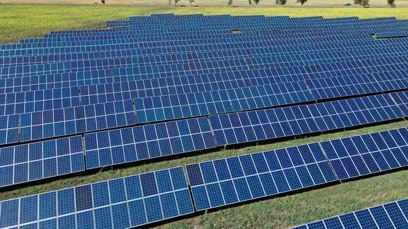 Aerial View of Solar Panels Farm on Green Field