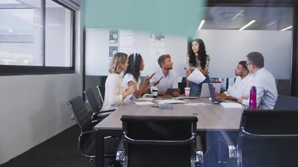 Professional businesspeople discussing together in modern office in slow motion