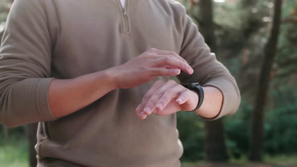 Tourist Asian Man Using Smartwatch in Forest Korean Student Use Smart Watch Application Trekking and
