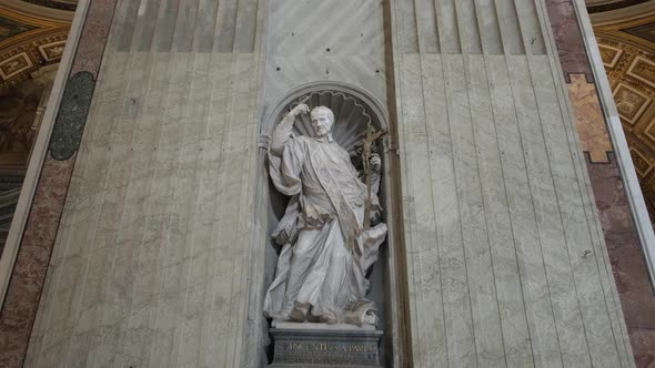 Statue of pope in the wall of St Peter Basilica.