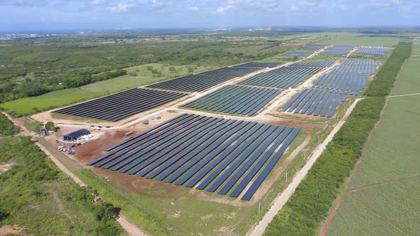 Aerial drone ascending pov over El Soco solar photovoltaic park of San Pedro De Macoris in Dominican