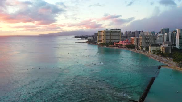 Sunset Reveal On Beautiful Waikiki Beach with Resort Hotels on Waterfront Tourism Destination In Hon