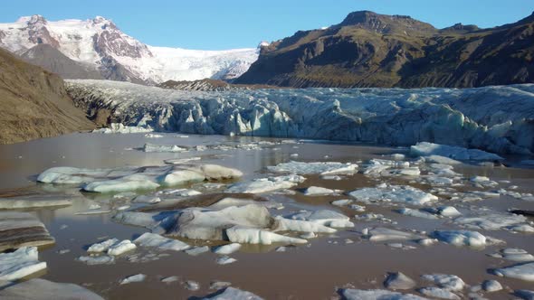 Aerial view of lagoon caused by global warming and massive Svinafellsjokull Glacier in Iceland.