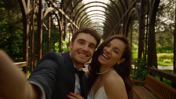 Joyful Man and Woman Doing Selfie Outdoors. Couple Smiling on Camera in Park